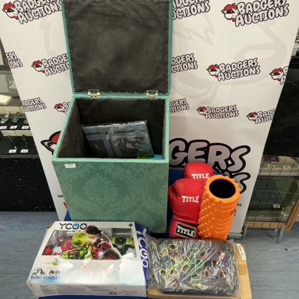 Green storage box filled with boxing gloves, toys, and fitness equipment.