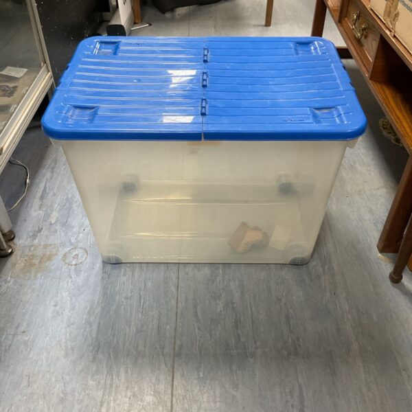 Large wheeled plastic storage box with lid.