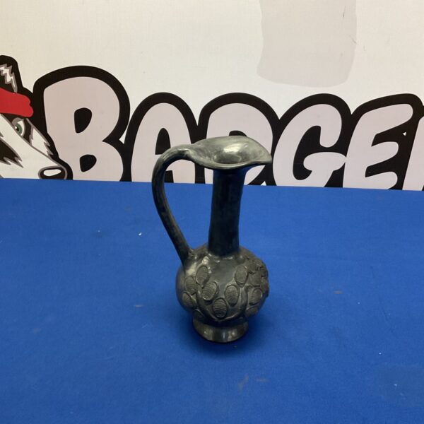 Vintage studio pottery jug with textured surface.