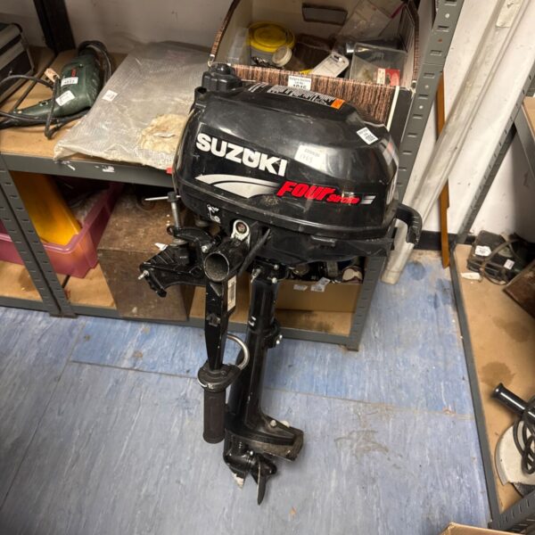 Black Suzuki outboard motor for boat, spares or repairs.
