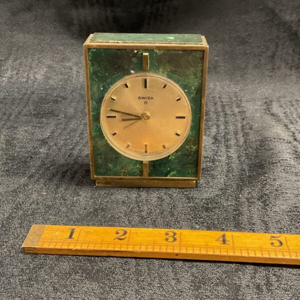 Vintage Swiza art deco travel clock with brass case and green panels.