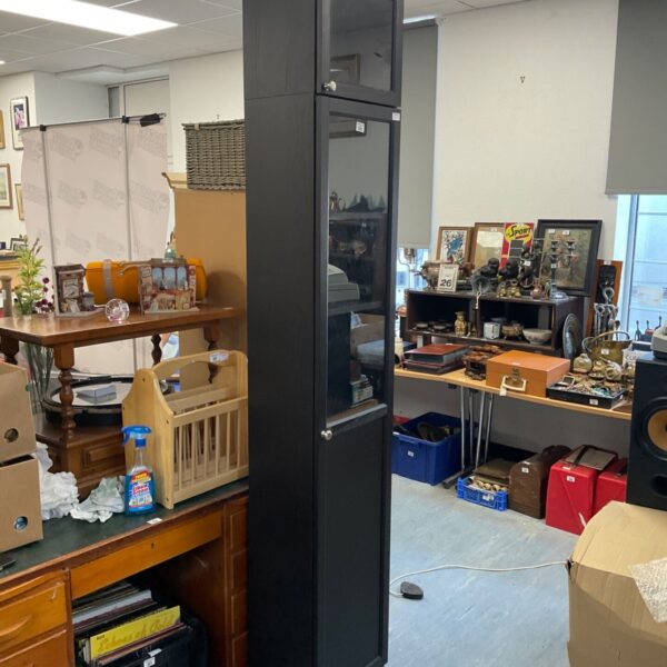 Darkwood tall display cabinet with shelves in a room setting.