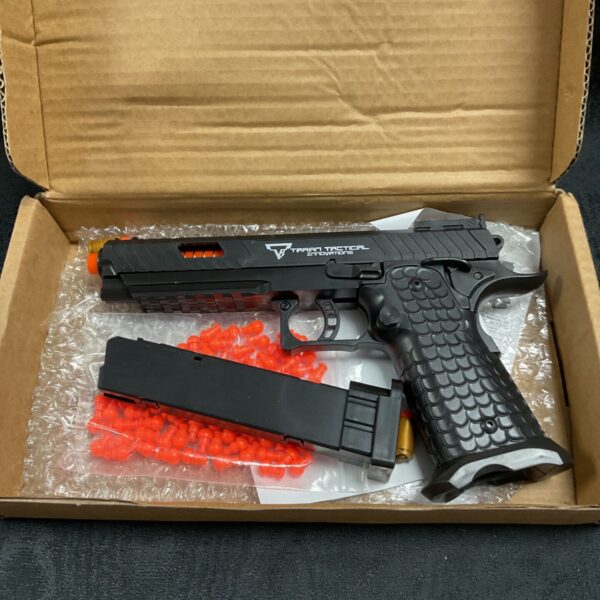 Taran Tactical airsoft pistol with metallic finish and tactical features.