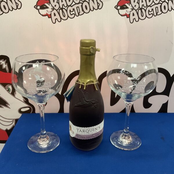 Sealed bottle of Tarquins Blackberry Gin with glasses.