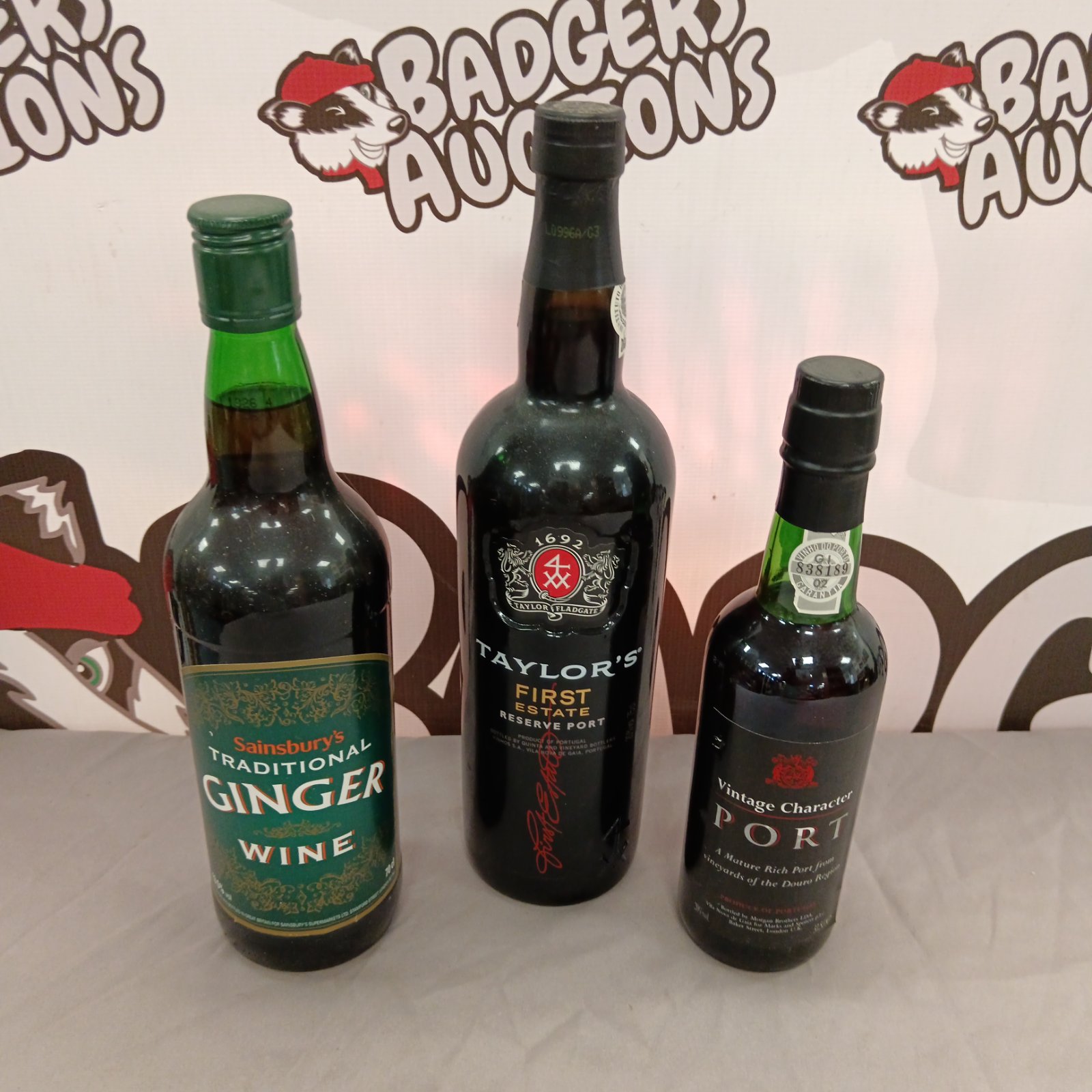 Vintage lot of port and ginger wine bottles for collectors.