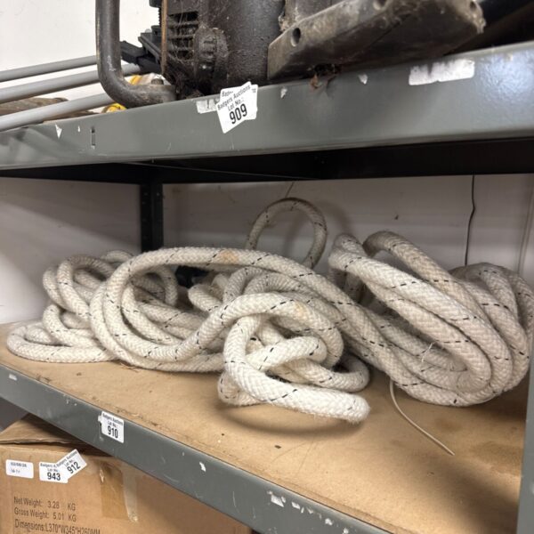 Long length of thick, natural fibre rope for nautical or industrial use.