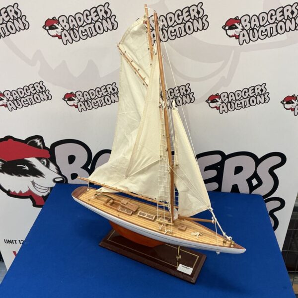 Detailed wooden model sailboat by Throness, a vintage nautical collectible.