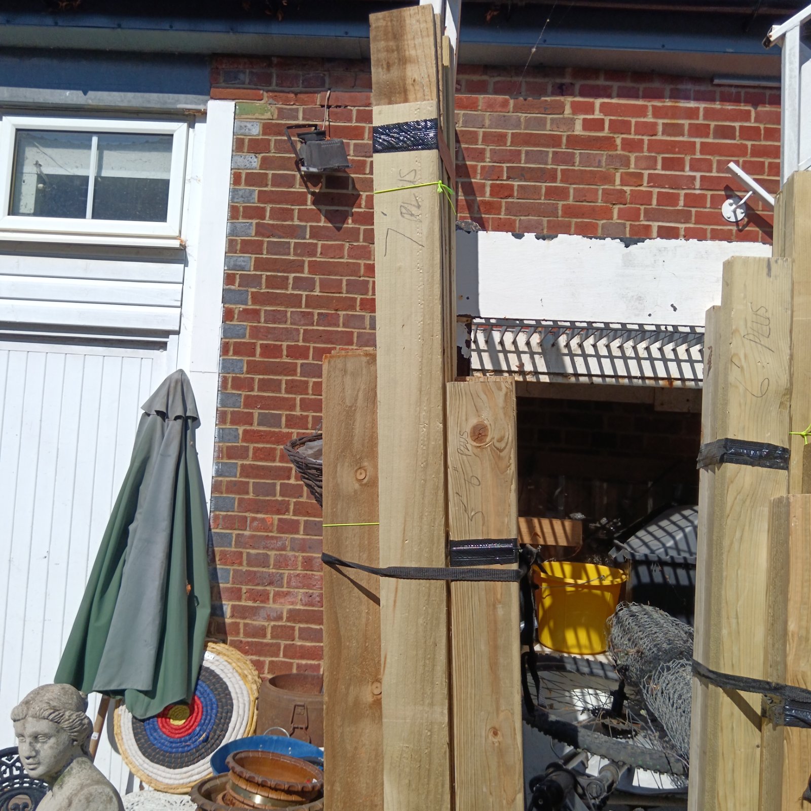 Timber bundles in a garden setting, suitable for DIY projects.