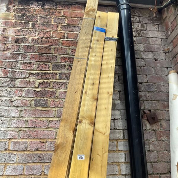 Three bundles of 10’6” timber stacked outdoors.