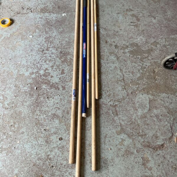 Job lot of vintage wooden tool handles for garden tools.