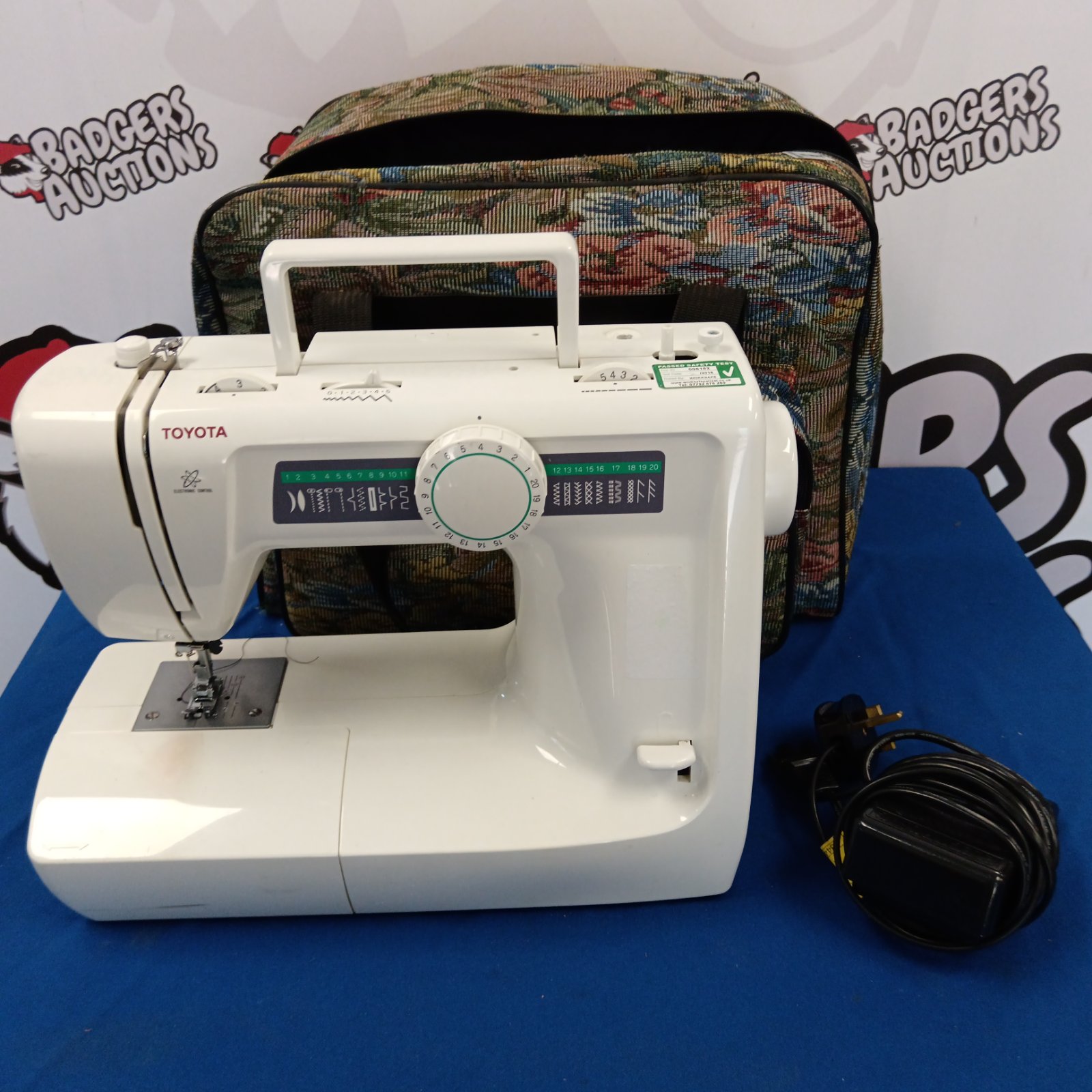 Vintage Toyota KB16 sewing machine with colourful patterned case.