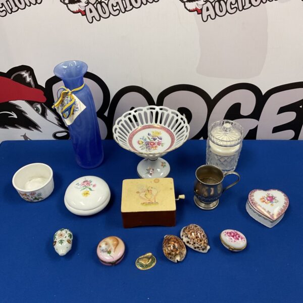 Collection of vintage trinket pots and accessories on blue background.