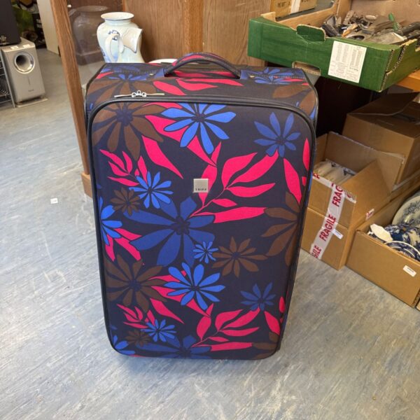 Large floral patterned Tripp wheeled suitcase for travel.