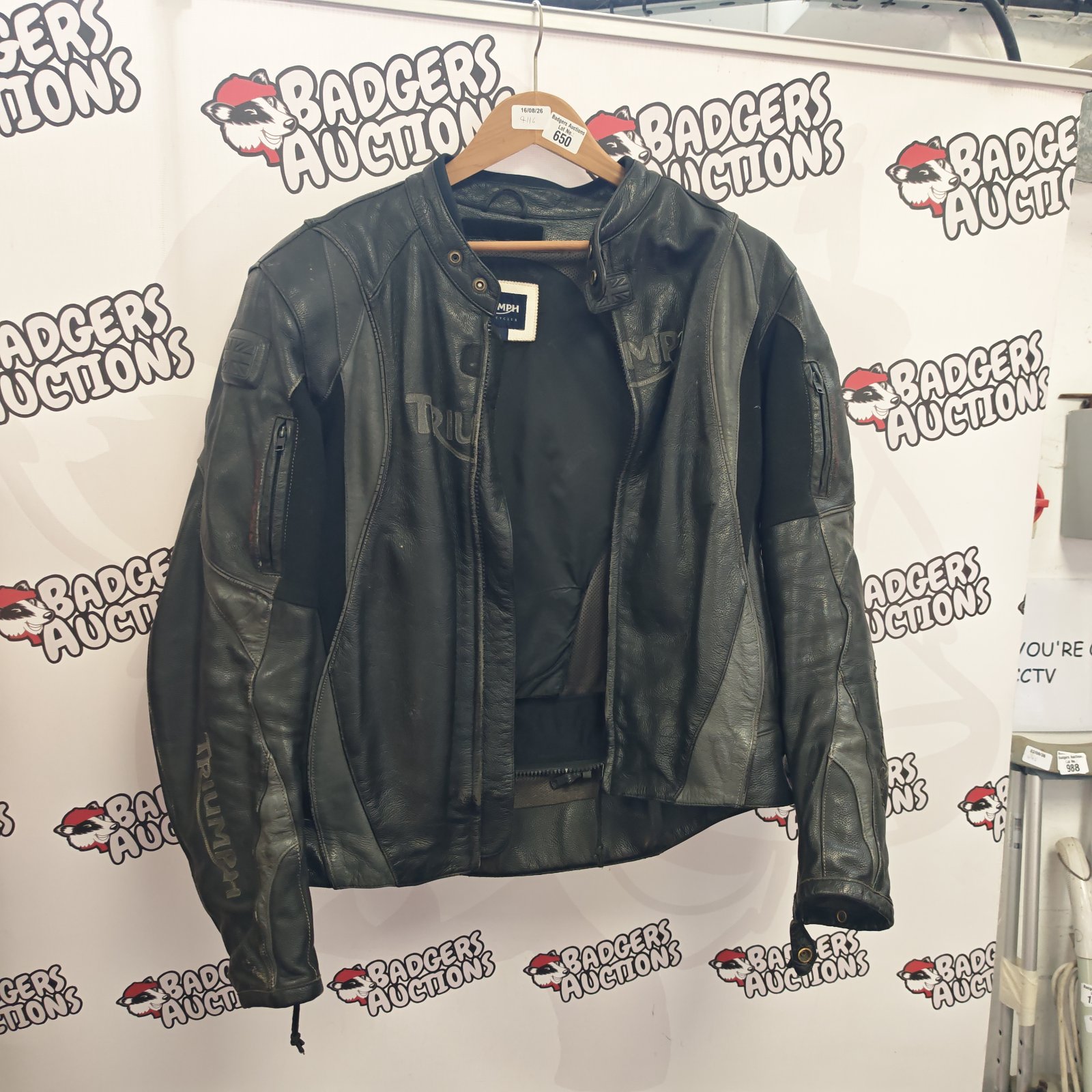 Front view of a vintage Triumph leather motorcycle jacket.