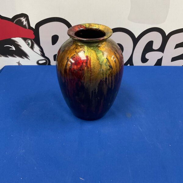 Vibrant Turkish art glass vase with red and orange swirls.