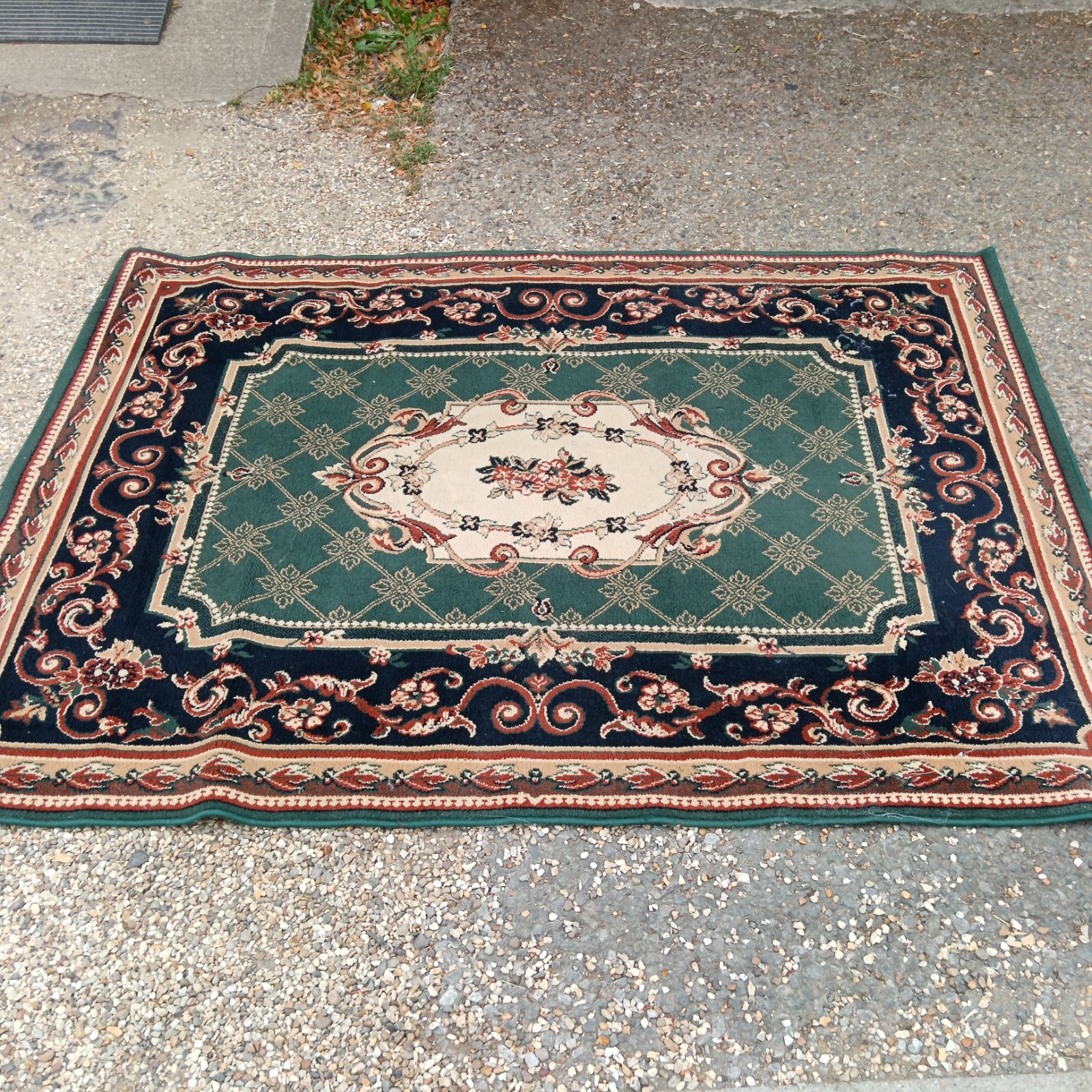 Traditional Turkish rug with a green and red medallion design.