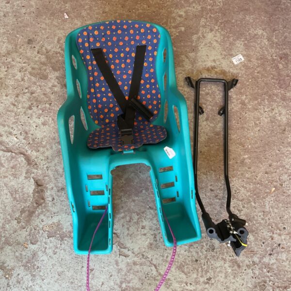 Turquoise rear-mounted child bicycle seat with harness.