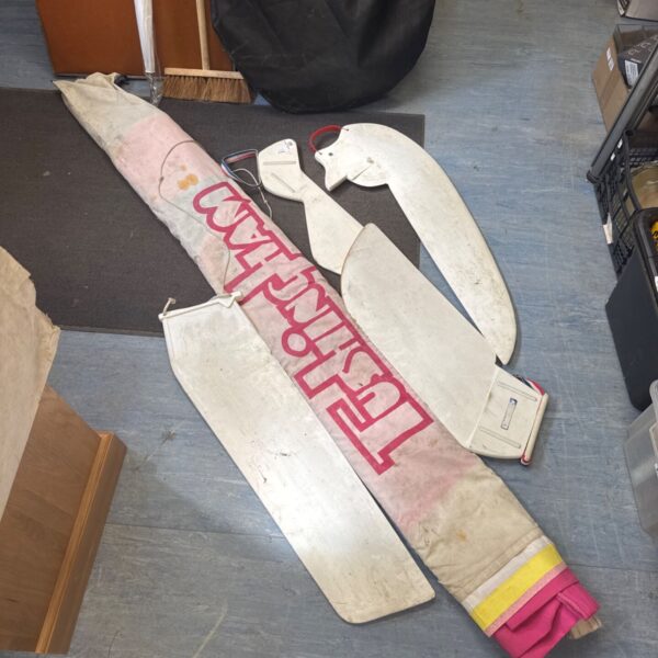 Vintage Tushingham windsurf sail with four fins attached.