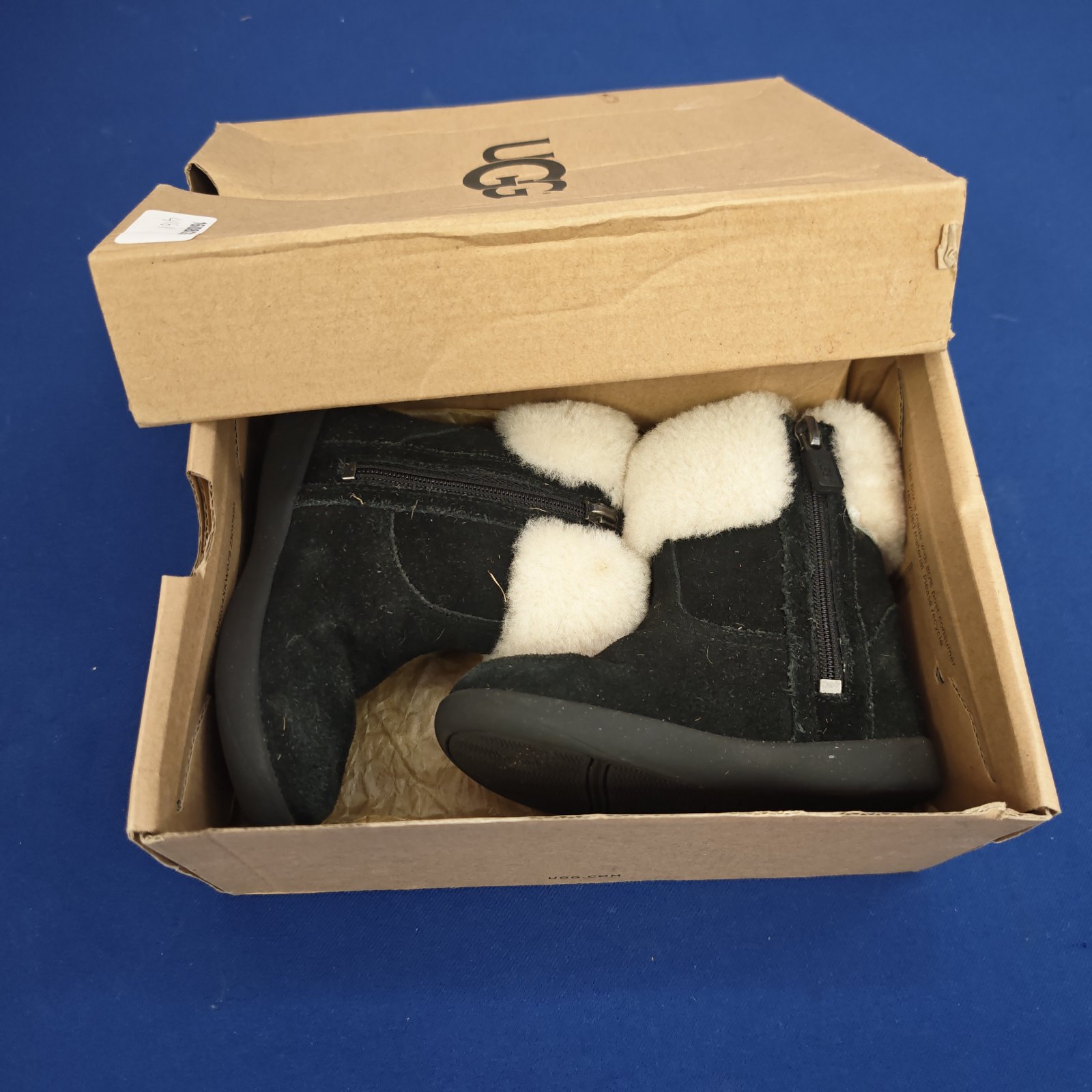 Pair of toddler UGG boots size 7 in a box.