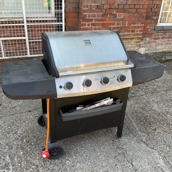 Black Ultar gas barbecue with four burners and wheels.