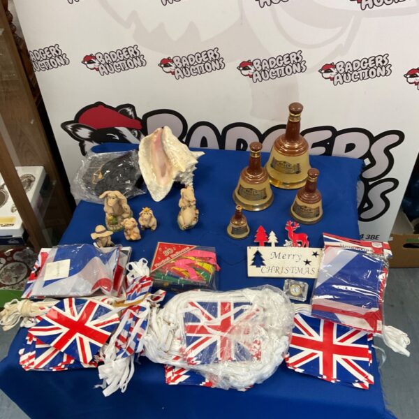 Union Flag bunting and flags with pig ornaments and conch shell.