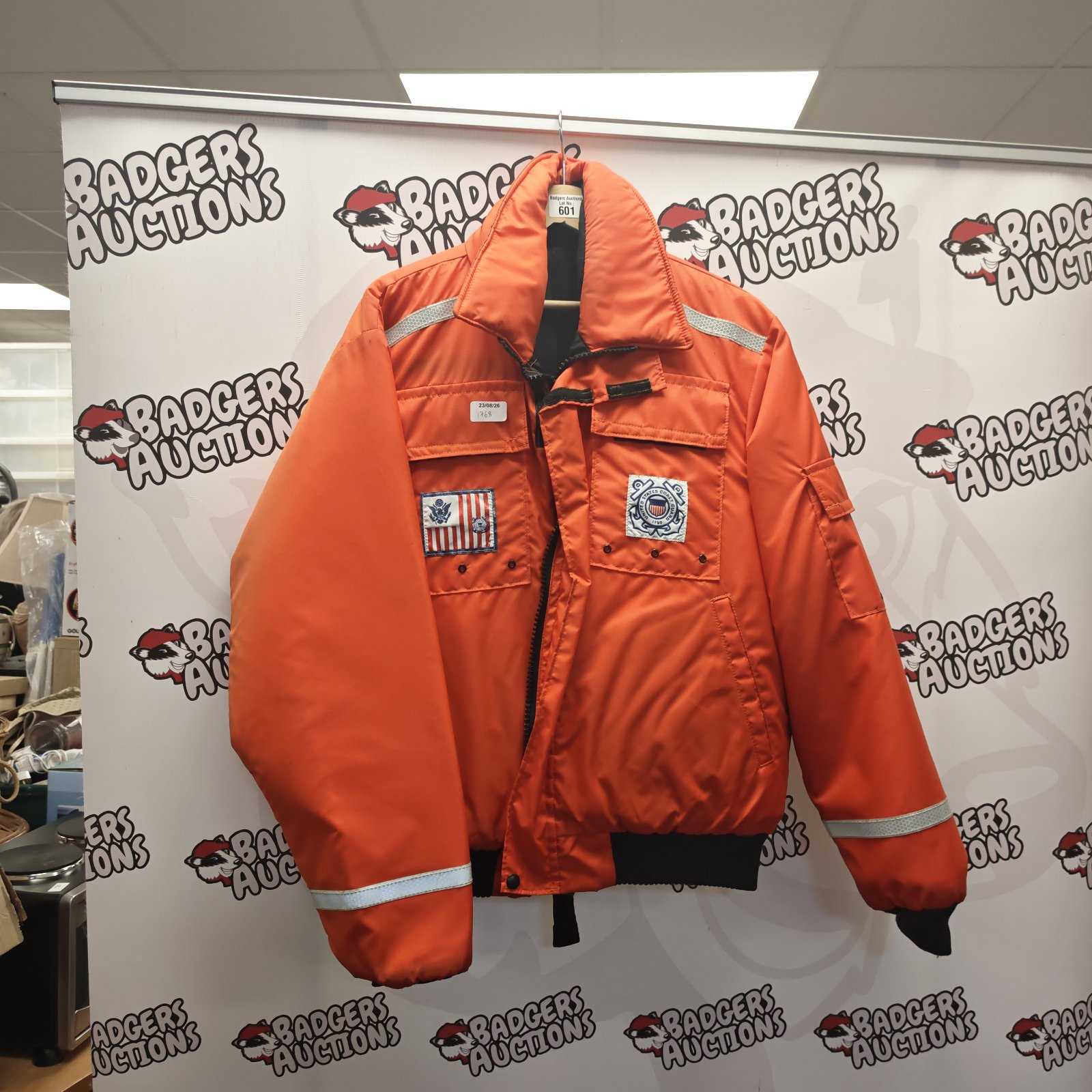 Orange US Coast Guard waterproof jacket with reflective tape.