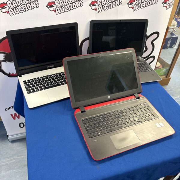 Lot of three used laptops including Asus and HP models.