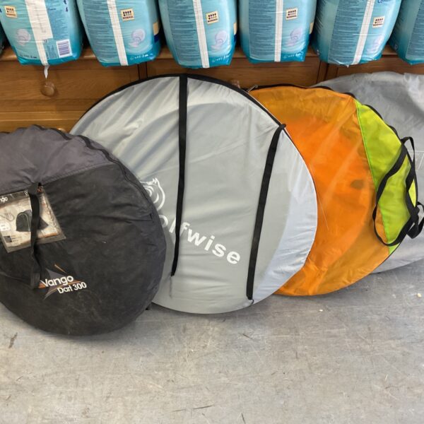 Folded Vango and Wolfwise pop up tents ready for camping.