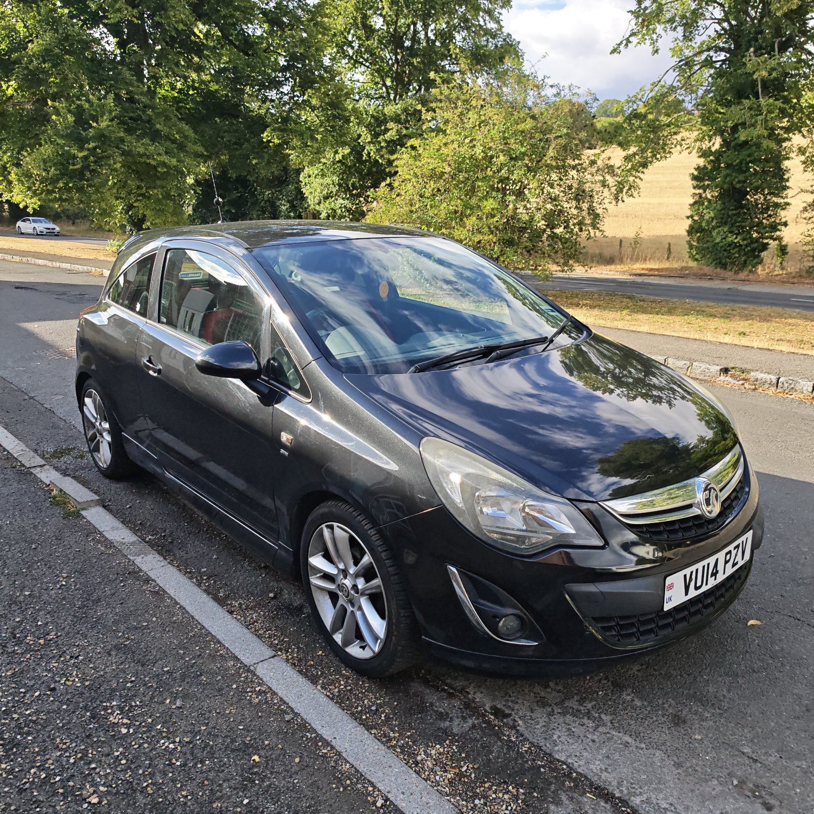 Black Vauxhall Corsa SRi parked on a road.