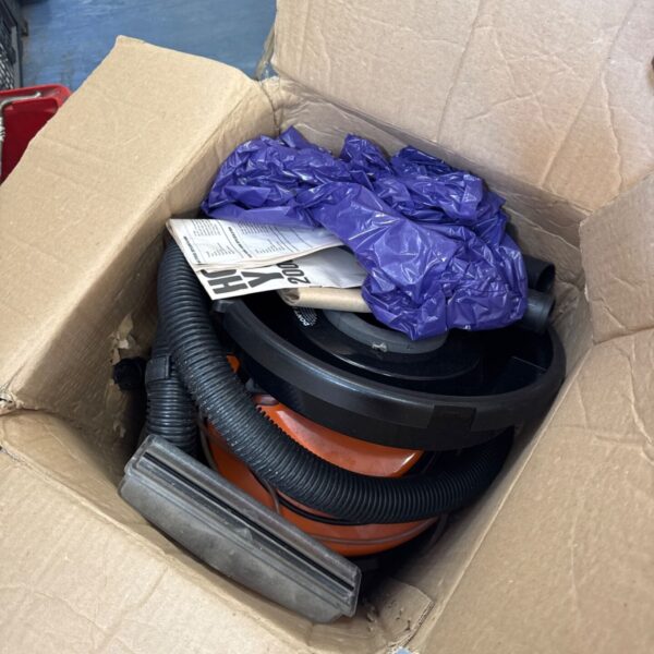 Vintage Vax 2000 vacuum cleaner in a cardboard box.