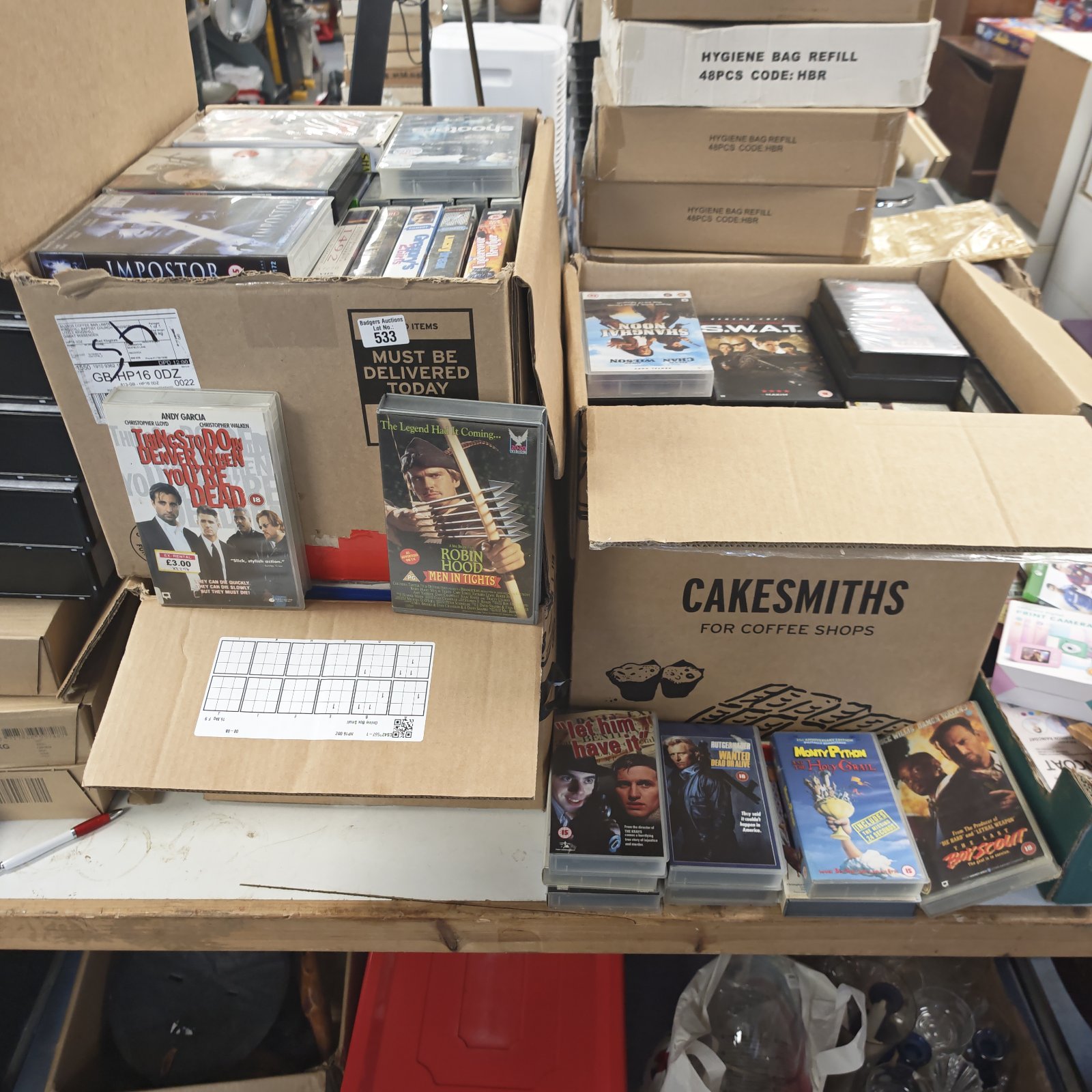 VHS movie lot with boxes of tapes including Robin Hood.