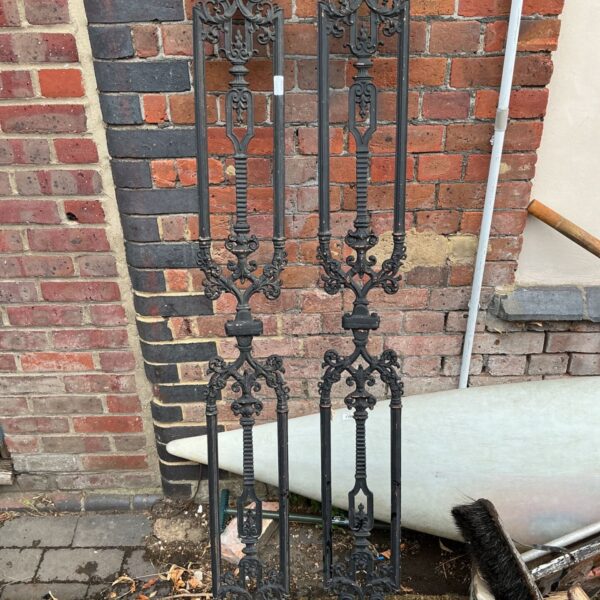 Ornate Victorian balusters, a pair of antique metal stair railing panels.