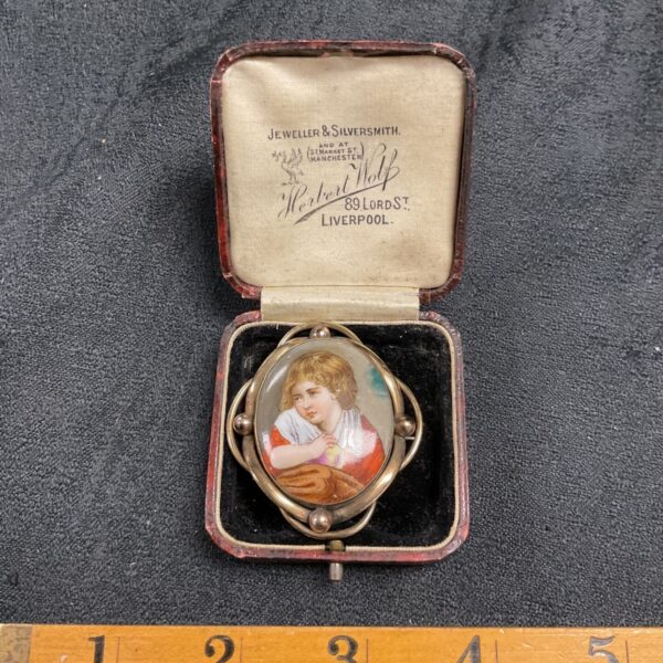 Antique Victorian enamel brooch with hand-painted boy portrait in leather box.