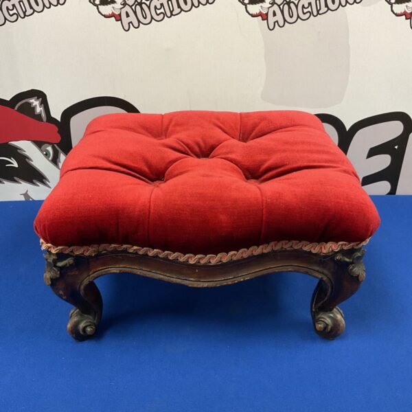 Antique Victorian red velvet footstool with carved legs.