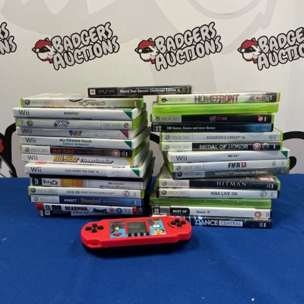 Video game lot including Xbox 360, Wii, and PC games like FIFA and Assassin's Creed.