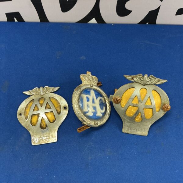 Vintage automobile badges including AA and RAC emblems.