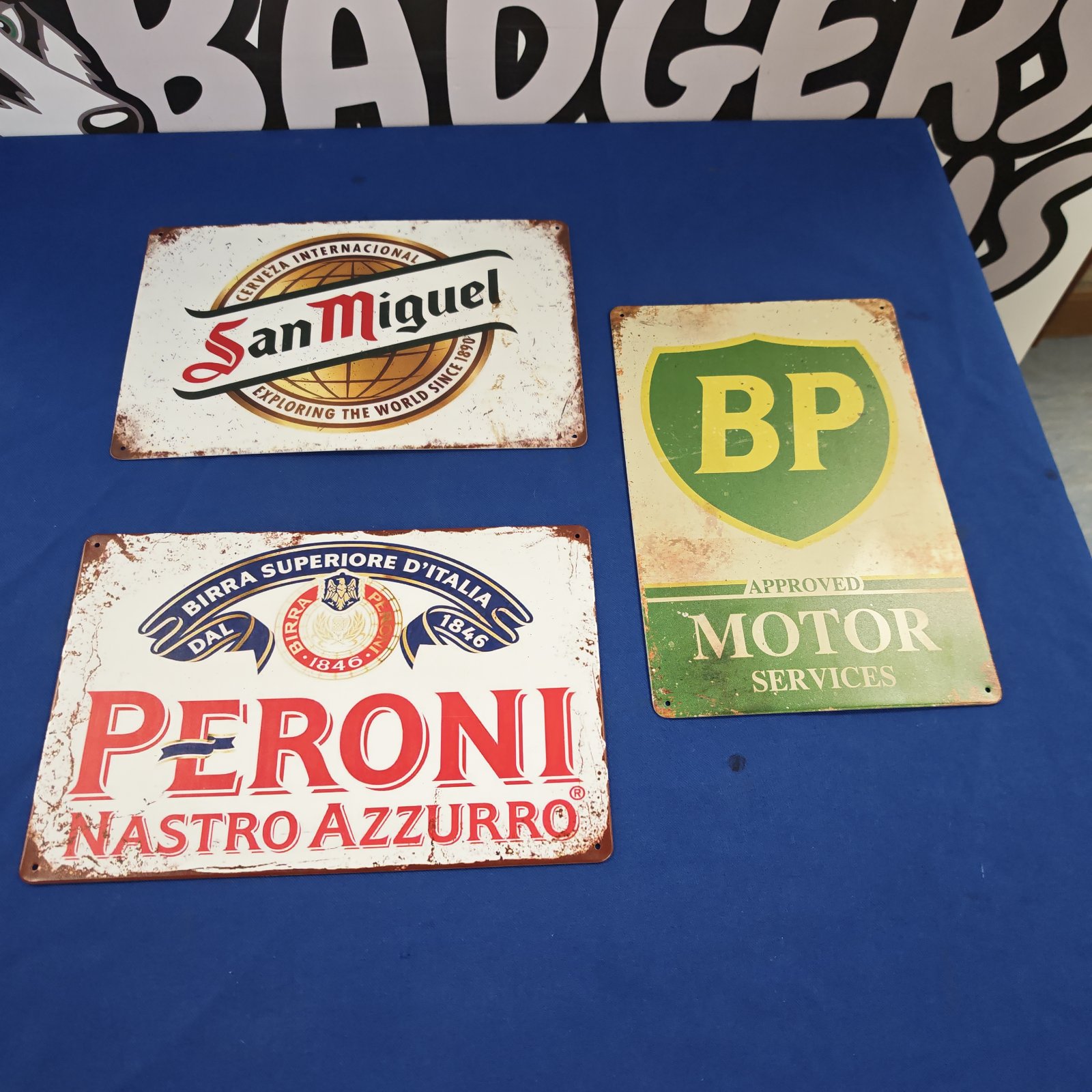Reproduction vintage advertising signs for BP, Peroni and San Miguel.
