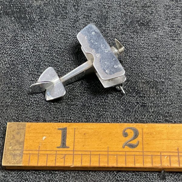Vintage silver aircraft pin badge, aviation collectible.