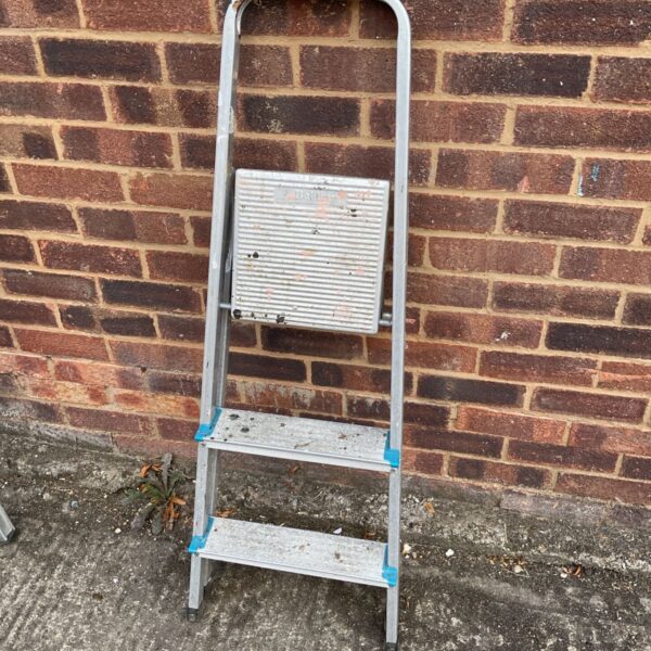 Vintage aluminum step ladder with three steps, ideal for DIY tasks.