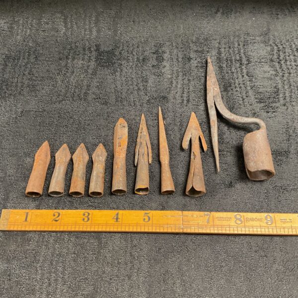 Collection of vintage metal arrowheads, antique historical artifacts.
