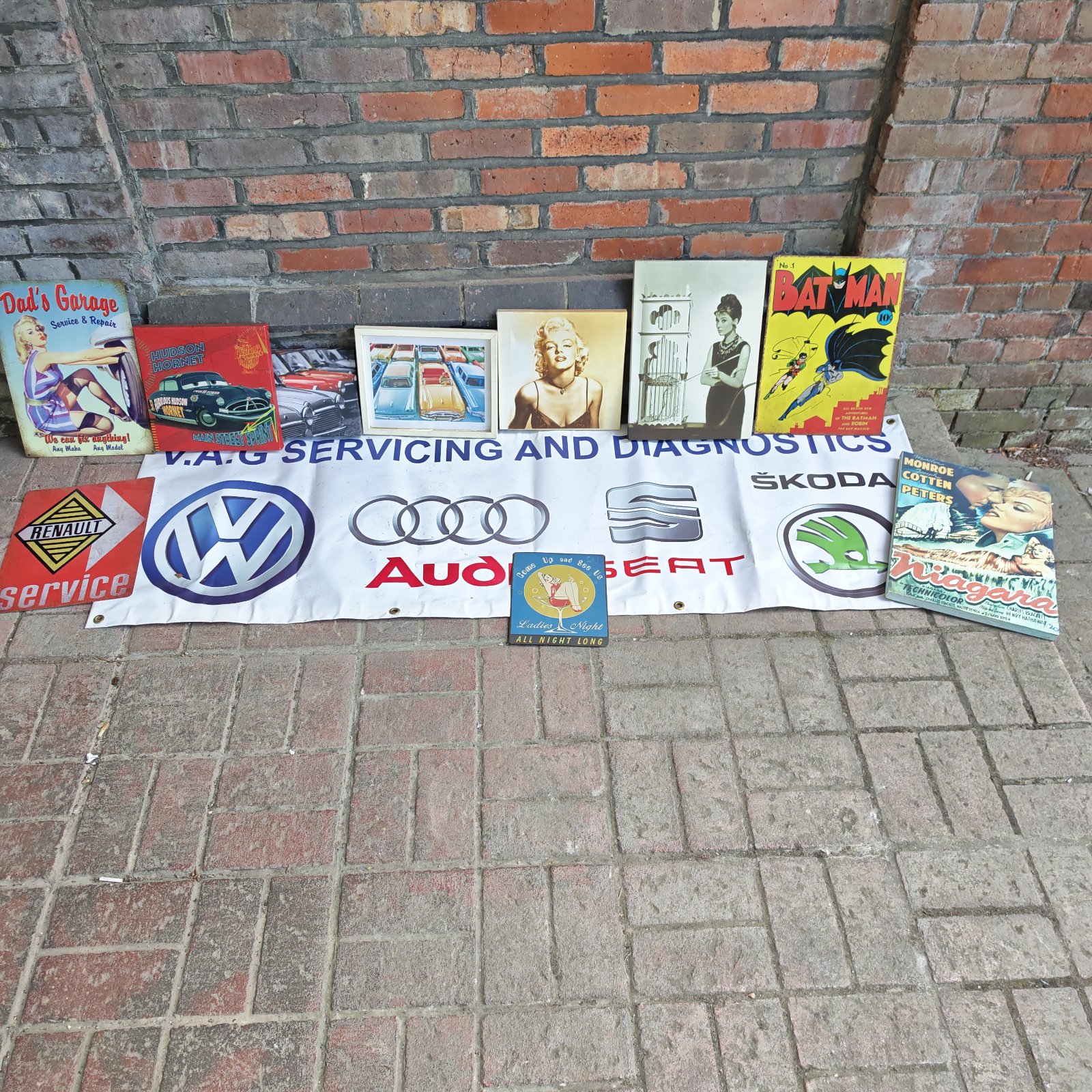 Lot of vintage automotive signs including VAG and Batman.
