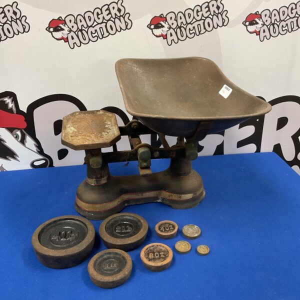 Vintage balance scales with cast iron weights for antique collecting.