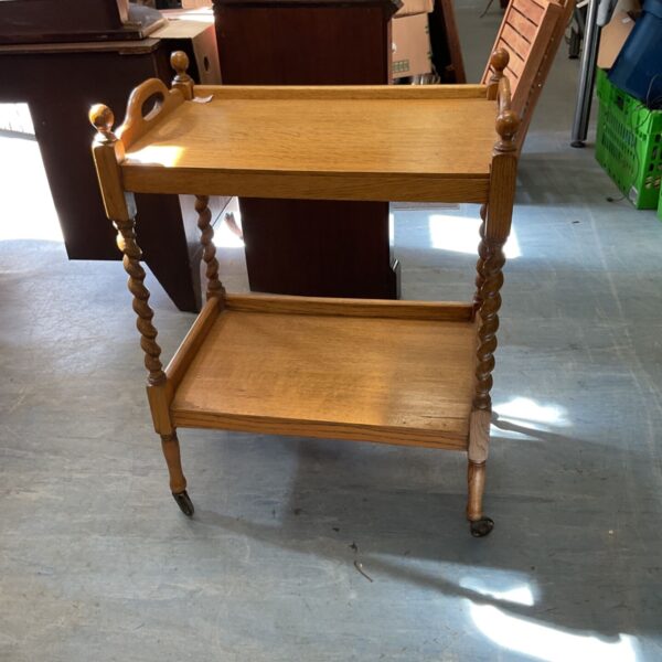 Vintage barley twist trolley with two tiers and wooden construction.