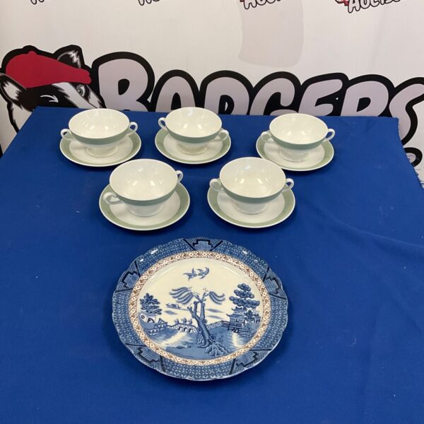 Vintage Booths Real Old Willow tea cups and plate set on display.