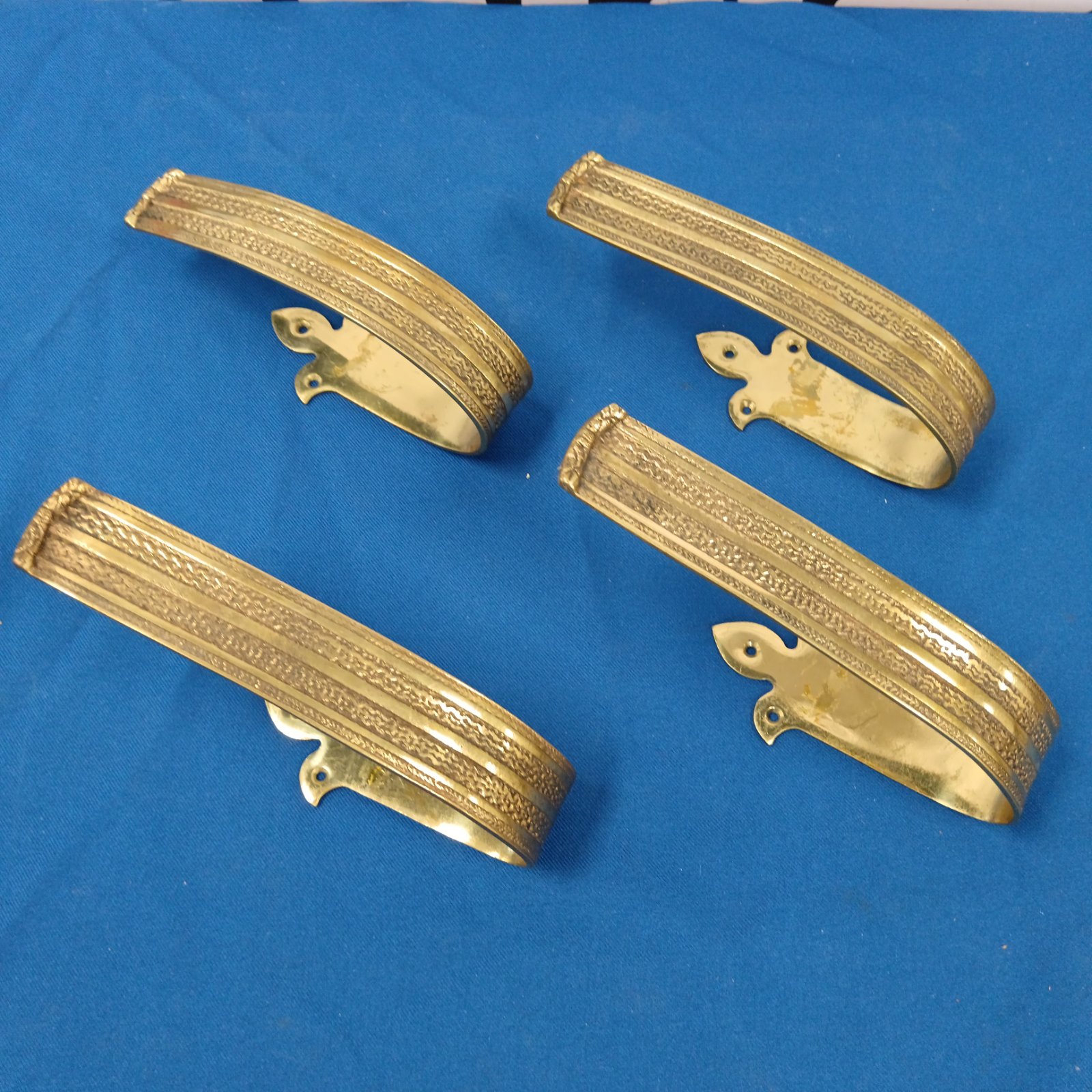 Vintage brass curtain tiebacks with floral embossed detailing.