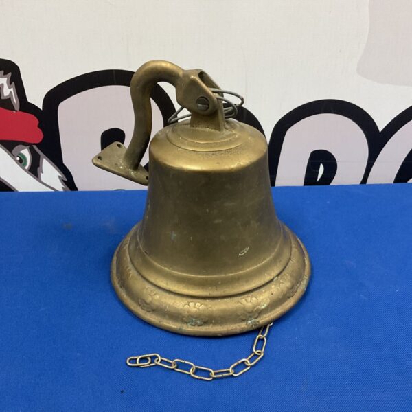 Vintage brass wall bell with daisy pattern, antique home decor.