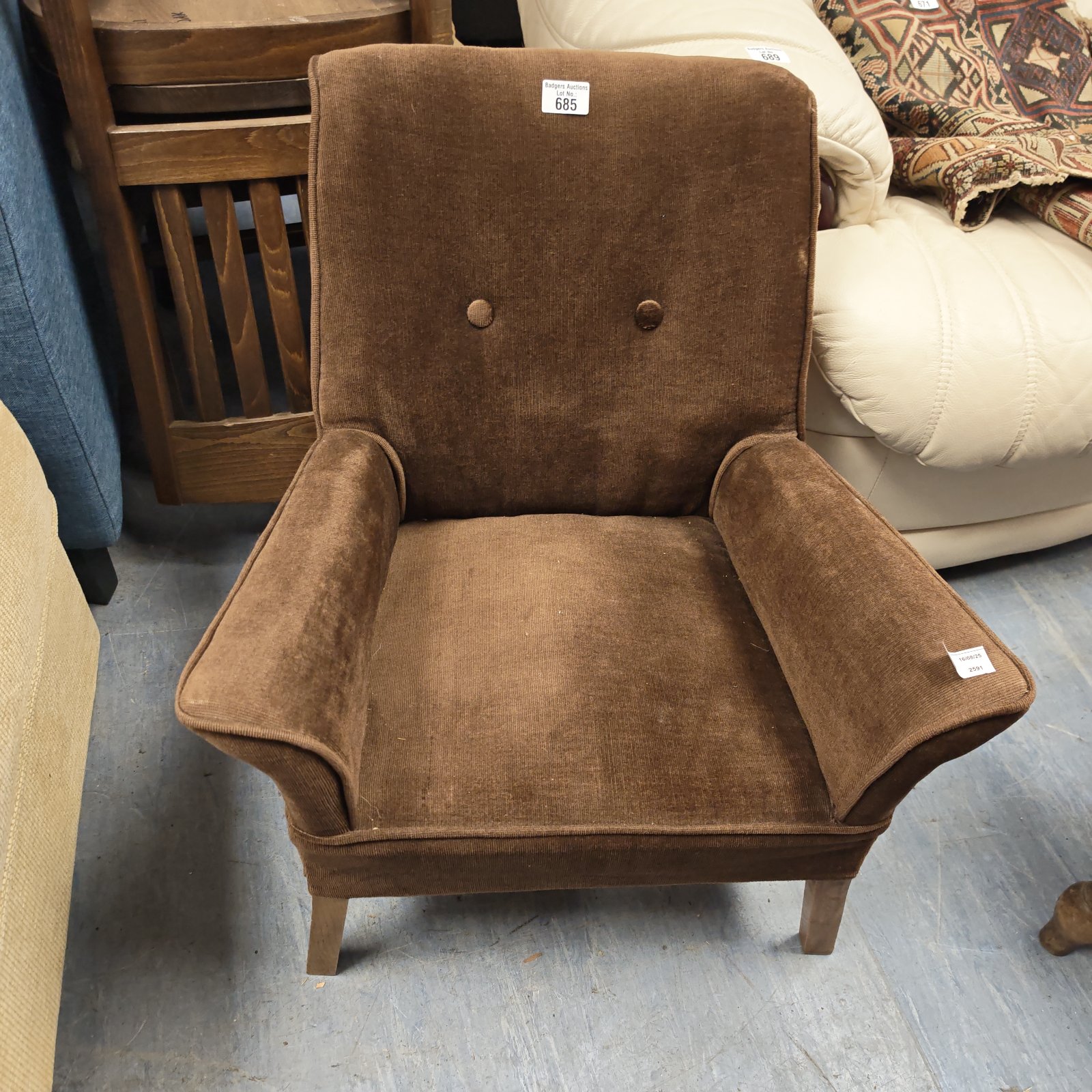 Vintage brown child's armchair with buttoned back.