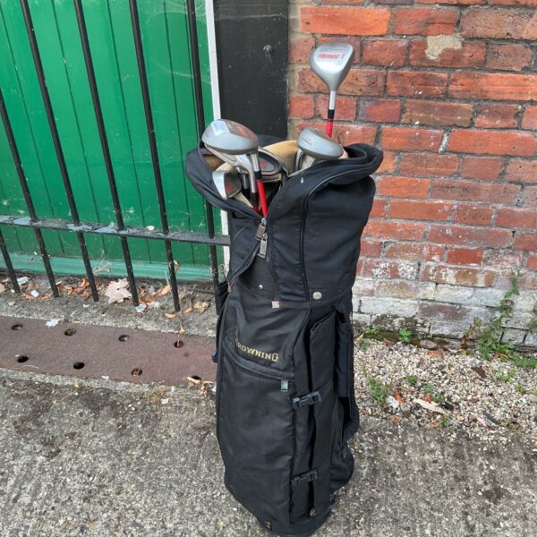 Vintage black Browning golf bag with assorted golf clubs.