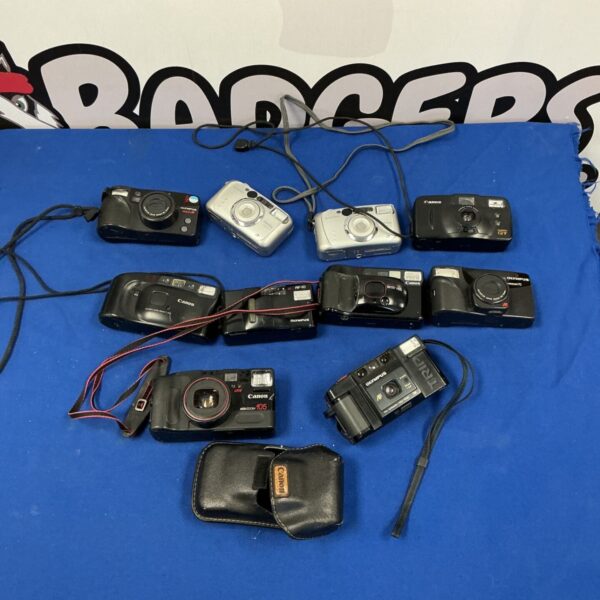 Vintage camera lot including Canon, Olympus, and Fujifilm cameras.