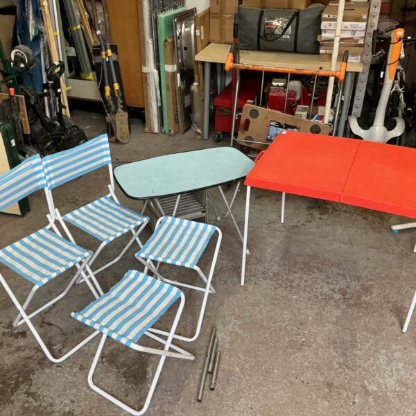 Vintage folding camping furniture set with striped chairs and tables.